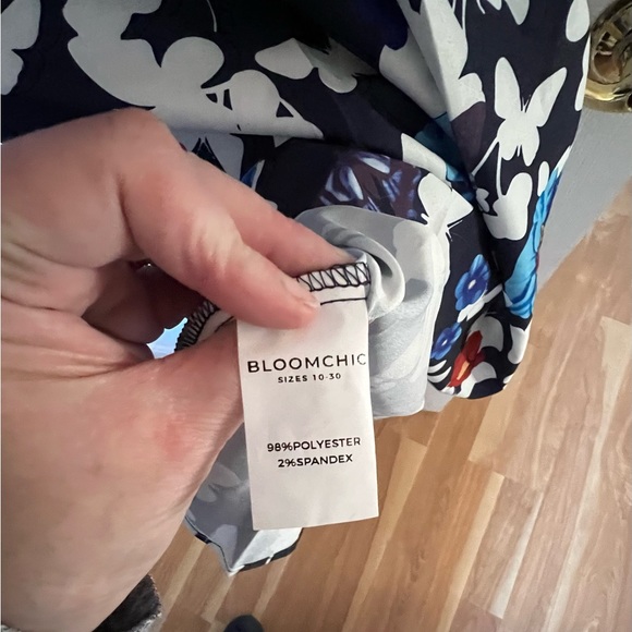 BloomChic ruffled sleeveless navy dress covered in butterflies. Below the knee. - Picture 5 of 7